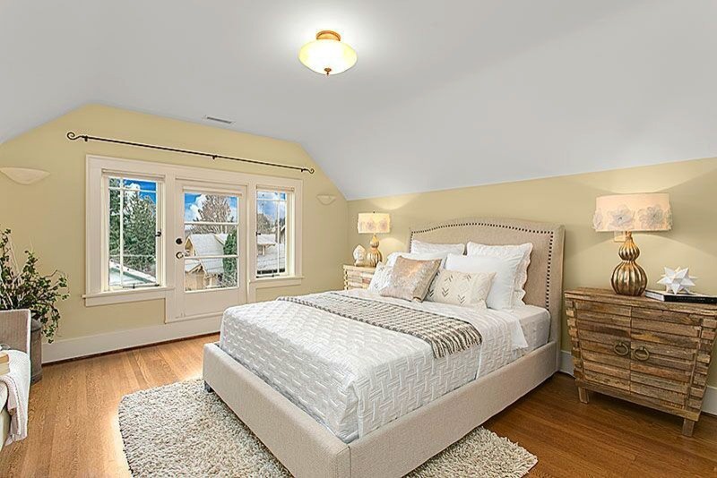 This is an example of a small transitional guest bedroom in Seattle with yellow walls, carpet and no fireplace.