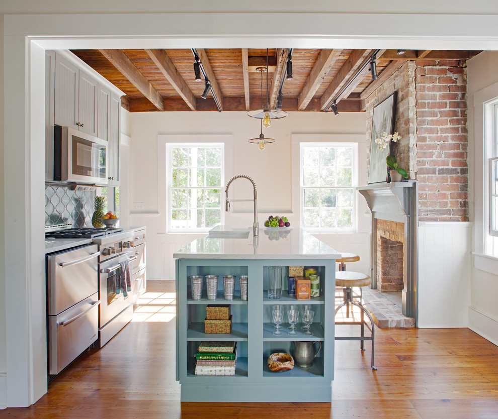 Inspiration for a small country galley eat-in kitchen in Atlanta with a farmhouse sink, beaded inset cabinets, grey cabinets, quartz benchtops, blue splashback, terra-cotta splashback, stainless steel appliances, medium hardwood floors, with island and brown floor.