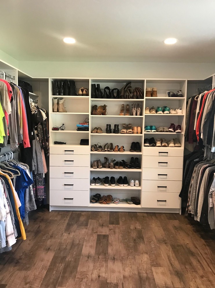 Inspiration for a large country gender-neutral walk-in wardrobe in Salt Lake City with flat-panel cabinets, white cabinets, medium hardwood floors and brown floor.