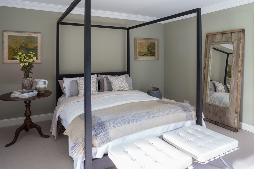 This is an example of a mid-sized traditional bedroom in London with green walls, carpet and grey floor.