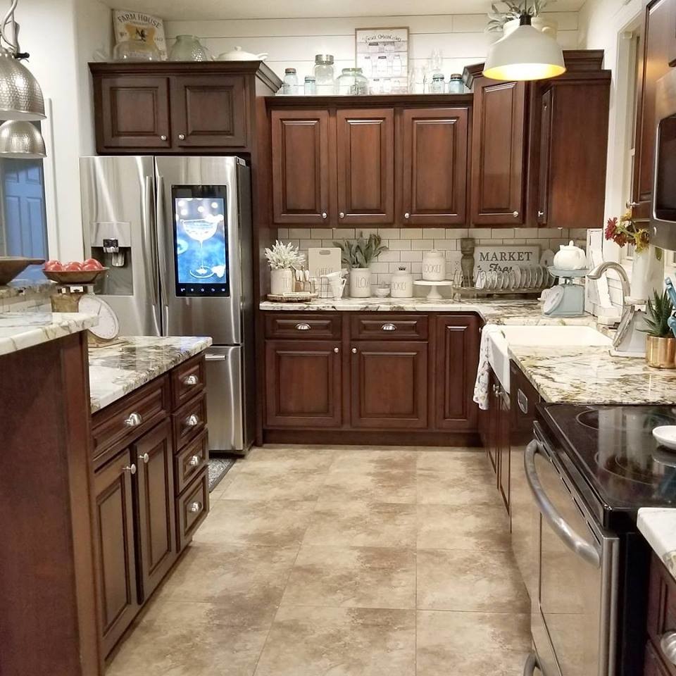 Large country l-shaped open plan kitchen in Chicago with a farmhouse sink, raised-panel cabinets, dark wood cabinets, terrazzo benchtops, white splashback, subway tile splashback, stainless steel appliances and with island.