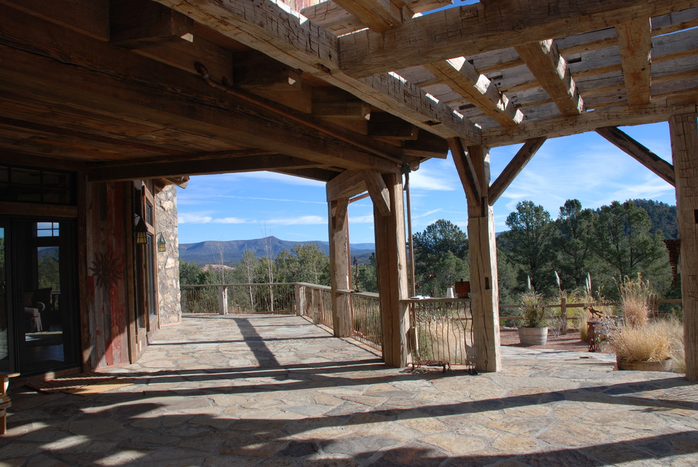 Inspiration for a huge rustic front door remodel in Phoenix with beige walls and a medium wood front door