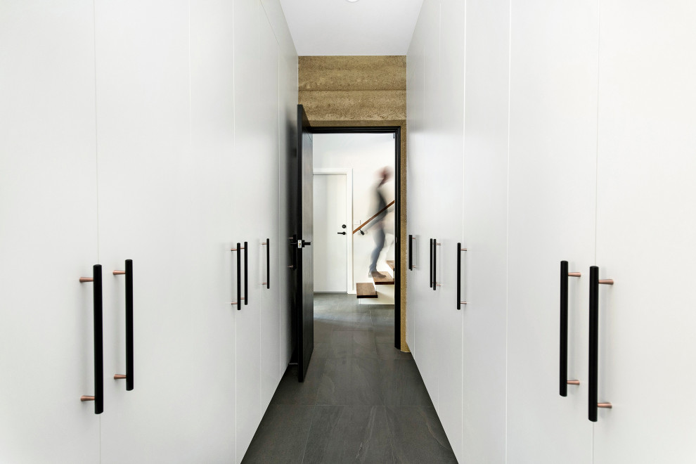 Mid-sized contemporary gender-neutral walk-in wardrobe in Canberra - Queanbeyan with flat-panel cabinets, white cabinets, porcelain floors and grey floor.
