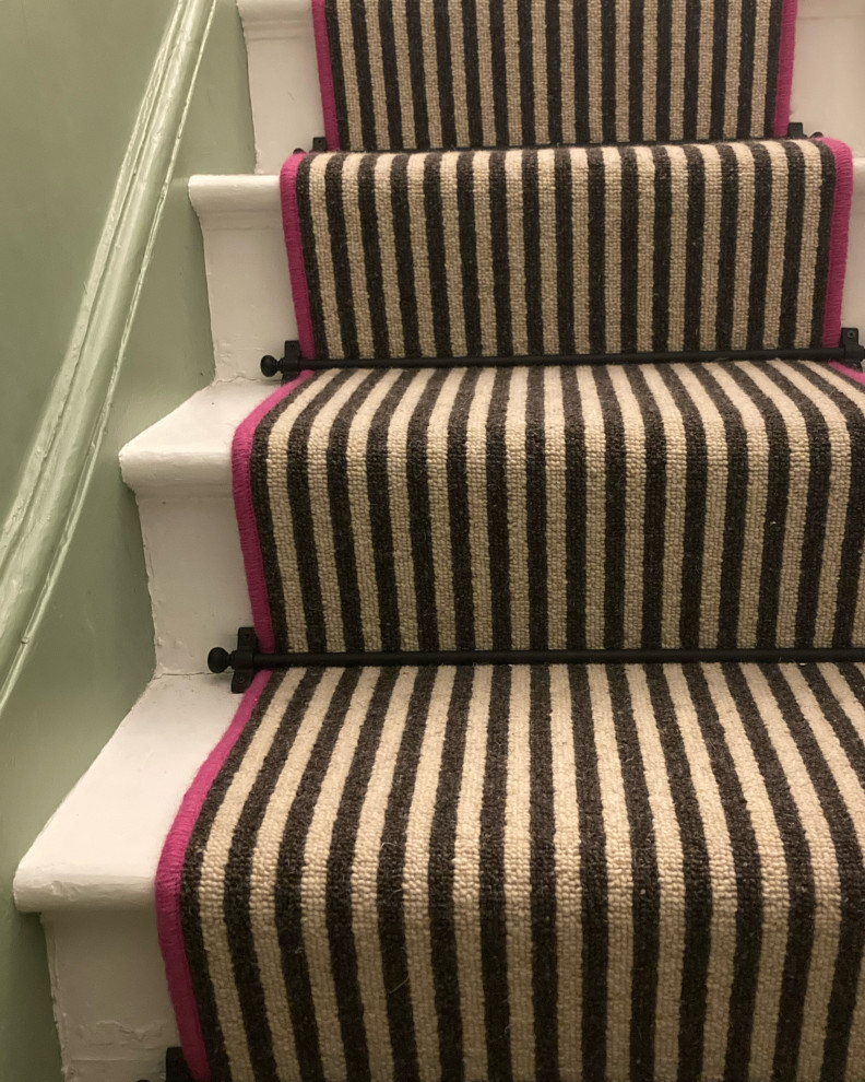 Photo of a mid-sized eclectic straight staircase in Sussex with carpet risers.