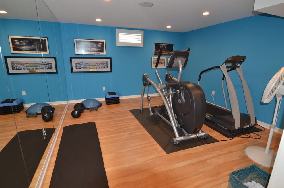 Large contemporary multipurpose gym in Philadelphia with blue walls and light hardwood floors.
