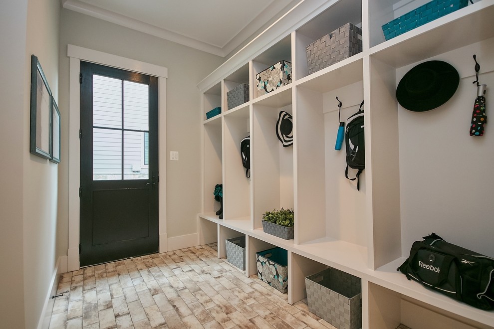 Inspiration for a mid-sized country mudroom in DC Metro with grey walls, medium hardwood floors, a single front door, a black front door and brown floor.