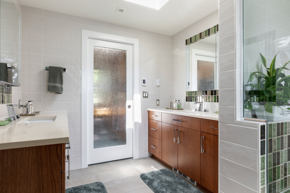 Design ideas for a large traditional ensuite bathroom in Seattle with flat-panel cabinets, medium wood cabinets, a double shower, a one-piece toilet, multi-coloured tiles, ceramic tiles, multi-coloured walls, porcelain flooring, a submerged sink, engineered stone worktops, beige floors, beige worktops, a single sink and a built in vanity unit.
