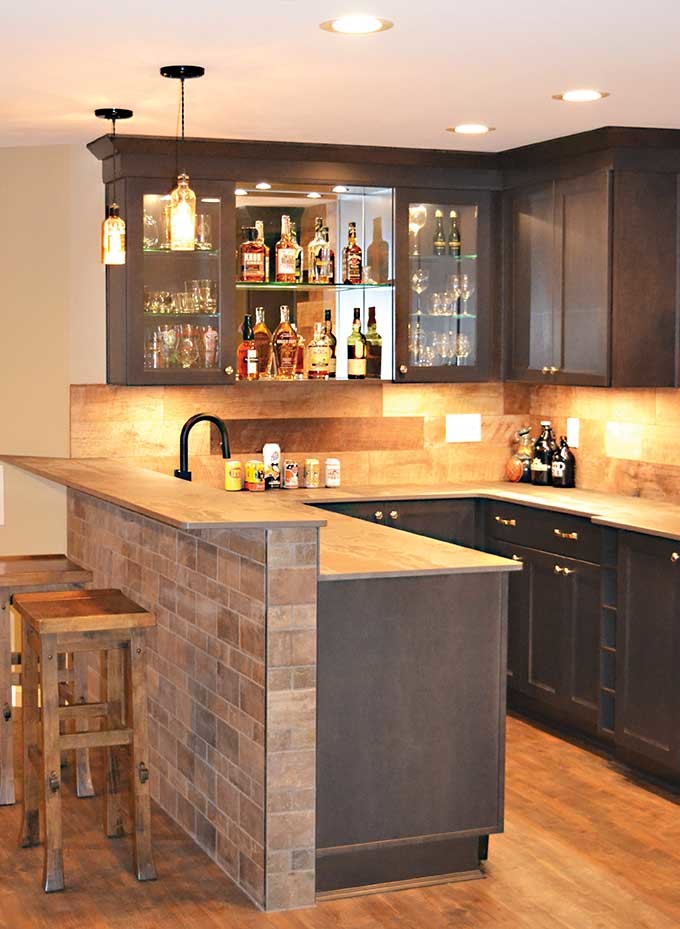 This is an example of a mid-sized country home bar in Cincinnati with vinyl floors and brown floor.