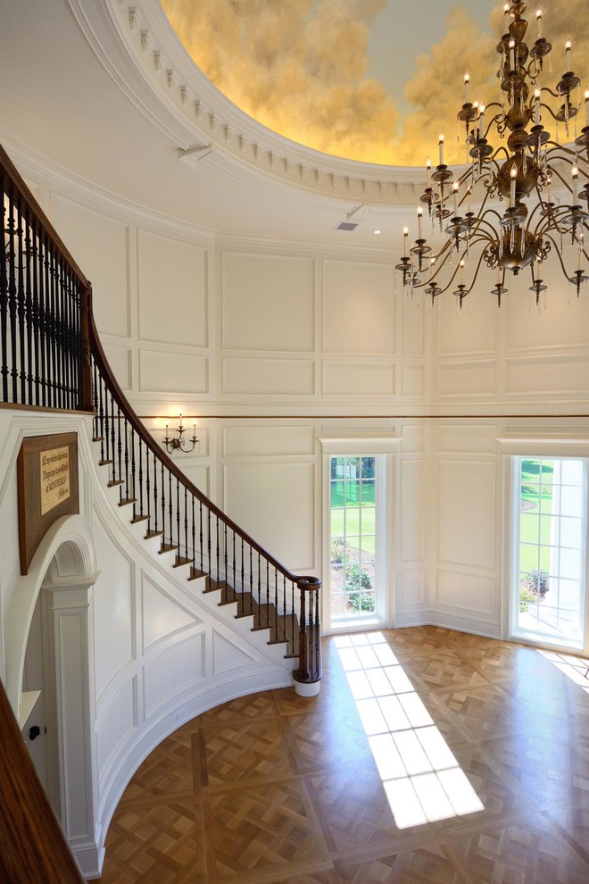 Inspiration for a large traditional foyer in Boston with white walls and light hardwood floors.