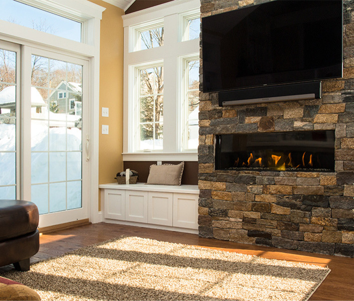 Design ideas for a mid-sized contemporary sunroom in Boston with a standard fireplace and a stone fireplace surround.
