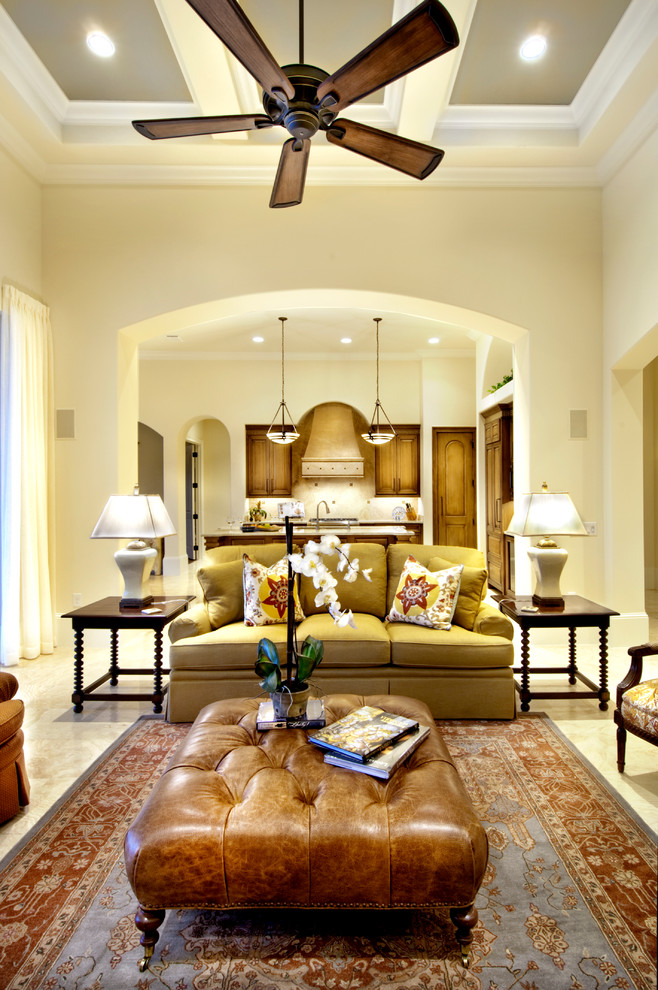 Design ideas for a traditional family room in Tampa with yellow walls and marble floors.