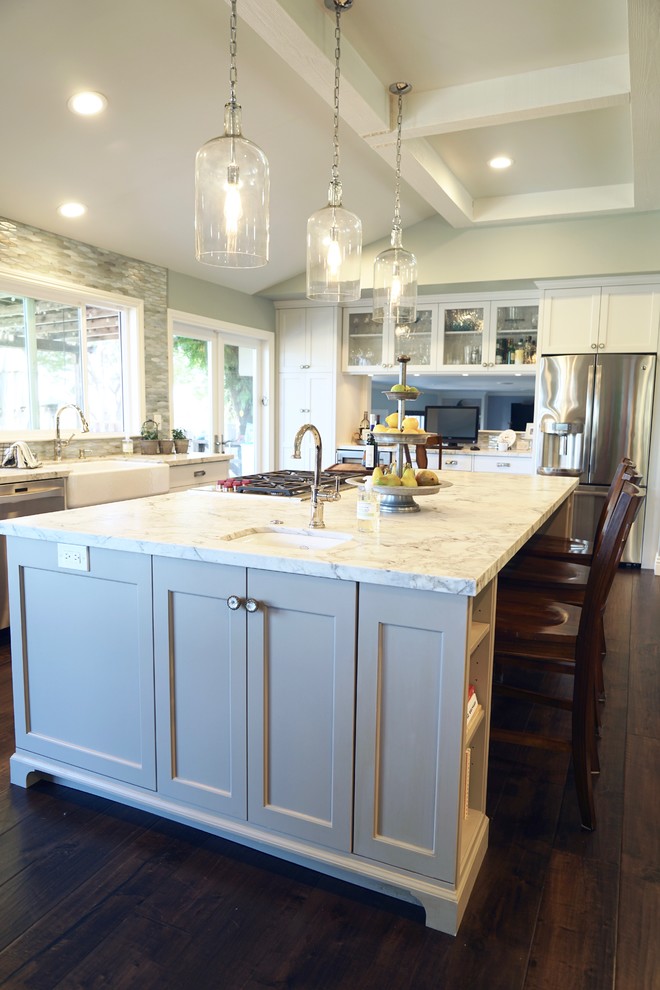 Inspiration for a large country l-shaped open plan kitchen in San Francisco with a farmhouse sink, shaker cabinets, white cabinets, quartzite benchtops, blue splashback, glass tile splashback, stainless steel appliances, medium hardwood floors and with island.