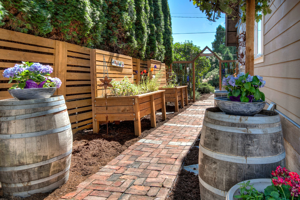 Design ideas for a mid-sized arts and crafts side yard full sun garden in Seattle with a vegetable garden and brick pavers.