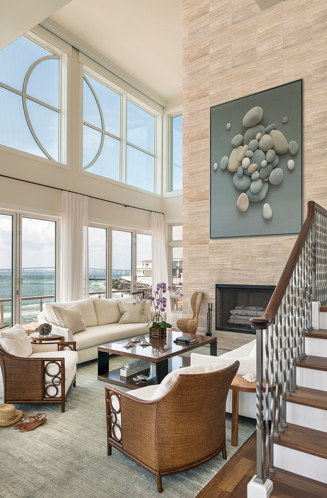 This is an example of a beach style living room in Philadelphia with beige walls, a standard fireplace and a tile fireplace surround.