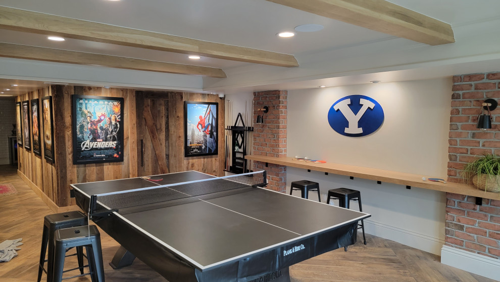 Photo of a large enclosed family room in Salt Lake City with a game room, white walls, vinyl floors, no tv, exposed beam and wood walls.