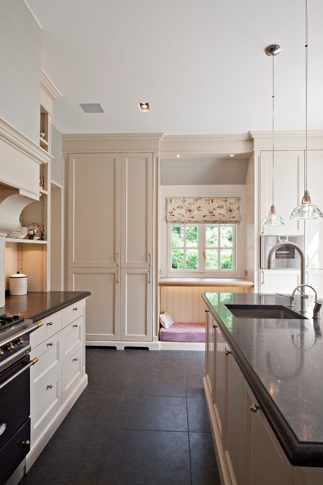 This is an example of a contemporary kitchen in New York with black appliances and recessed-panel cabinets.