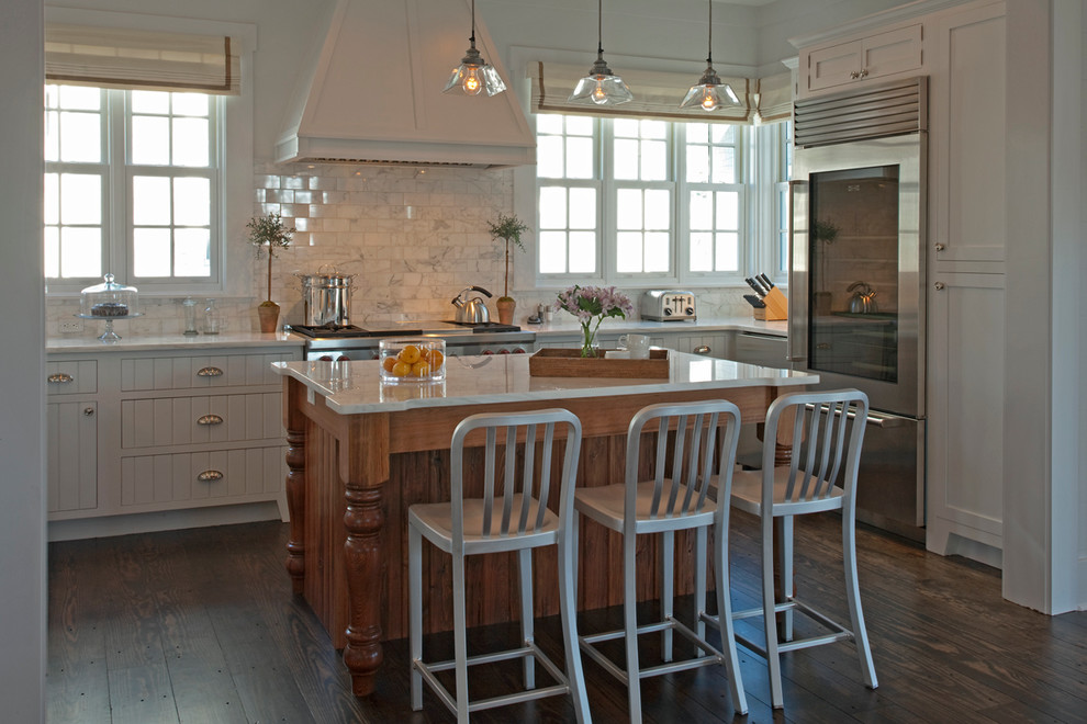 Inspiration for a large transitional u-shaped dark wood floor eat-in kitchen remodel in Miami with a farmhouse sink, louvered cabinets, white cabinets, marble countertops, white backsplash, marble backsplash, stainless steel appliances and an island