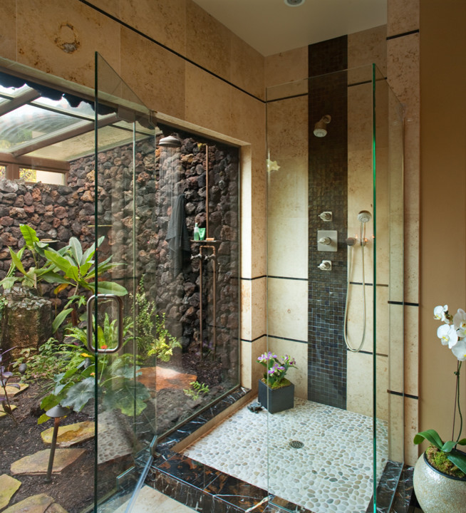 Inspiration for a mid-sized tropical master bathroom in San Diego with an open shower, a one-piece toilet, black tile, stone tile, beige walls, ceramic floors, a vessel sink and a hinged shower door.