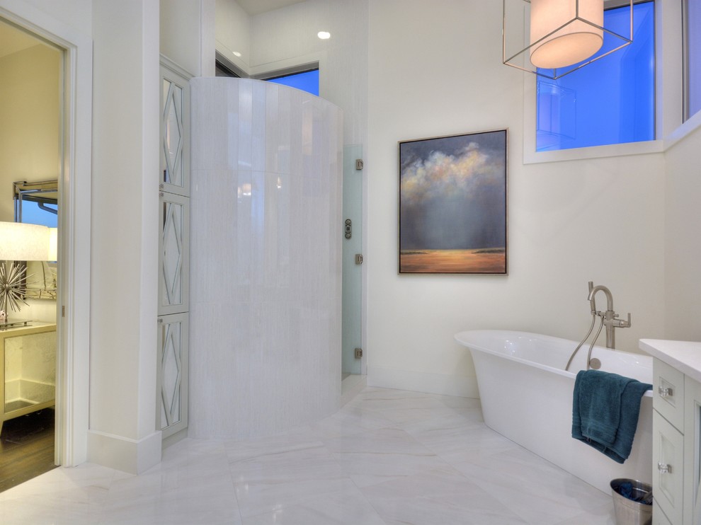 Photo of a transitional master bathroom in Austin with beaded inset cabinets, white cabinets, a freestanding tub, a corner shower and white tile.