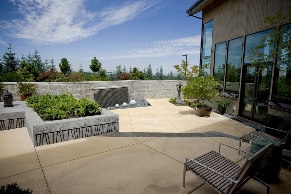 Inspiration for a contemporary patio in Portland with concrete slab and no cover.