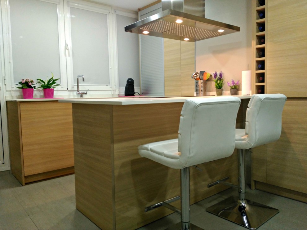 Photo of a small contemporary galley eat-in kitchen in Other with flat-panel cabinets, medium wood cabinets and a peninsula.