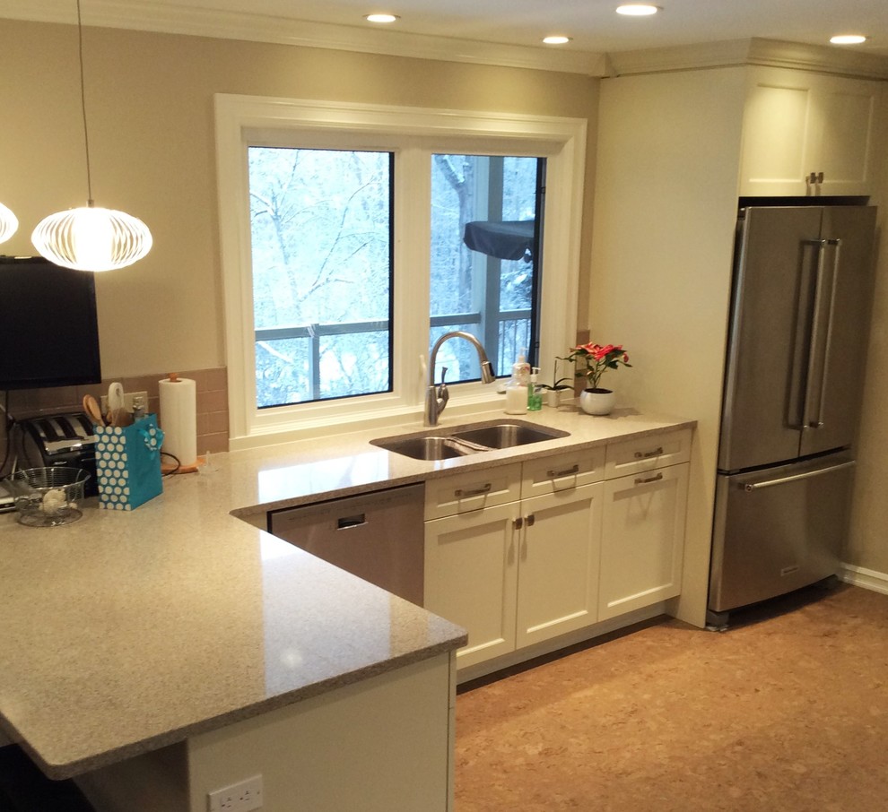 Transitional cork floor kitchen photo in Edmonton with white cabinets, quartzite countertops, gray backsplash, ceramic backsplash and stainless steel appliances