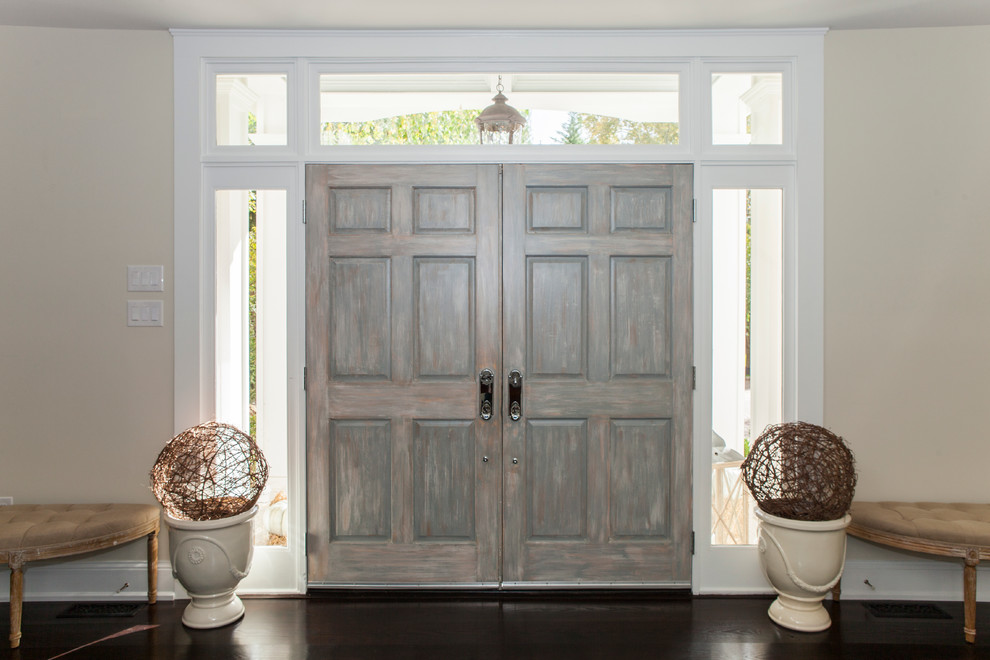 Photo of an expansive transitional foyer in Philadelphia with beige walls, dark hardwood floors and a double front door.