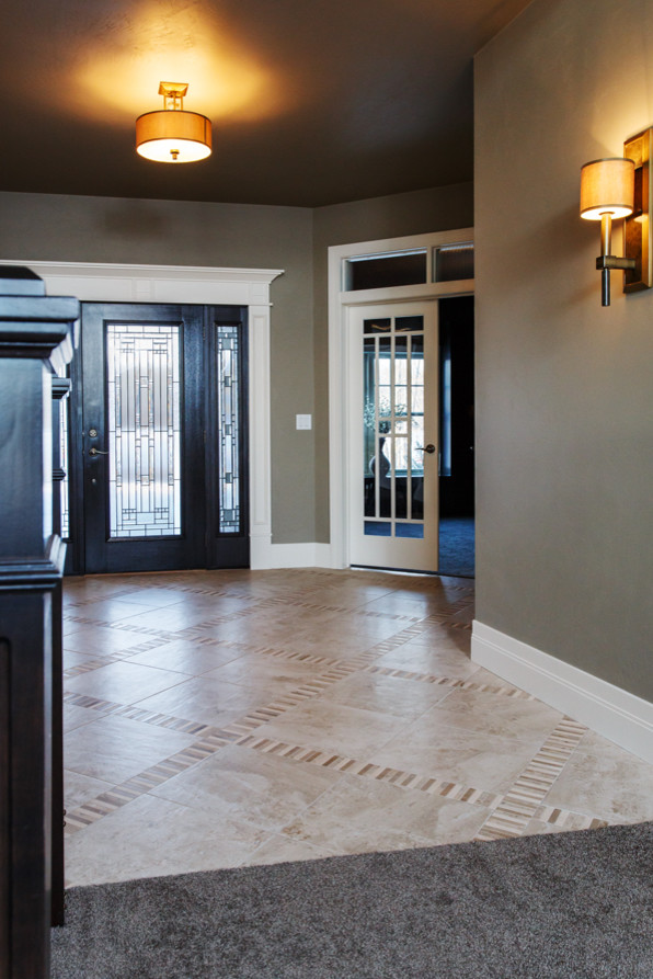 Example of a large transitional vinyl floor and beige floor foyer design with beige walls and a dark wood front door