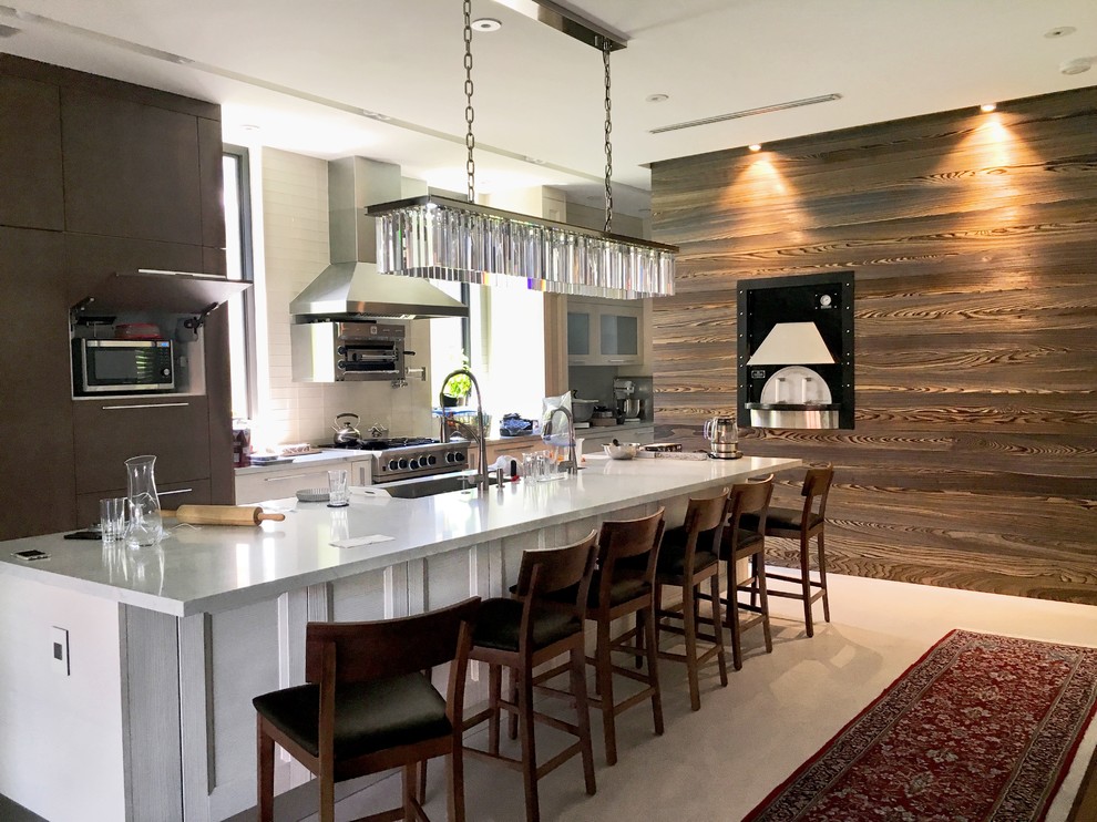 Photo of a large contemporary single-wall separate kitchen in Miami with an undermount sink, flat-panel cabinets, medium wood cabinets, marble benchtops, white splashback, subway tile splashback, panelled appliances, concrete floors, with island and grey floor.
