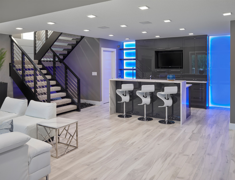 Photo of a large contemporary walk-out basement in Edmonton with grey walls, ceramic floors and grey floor.