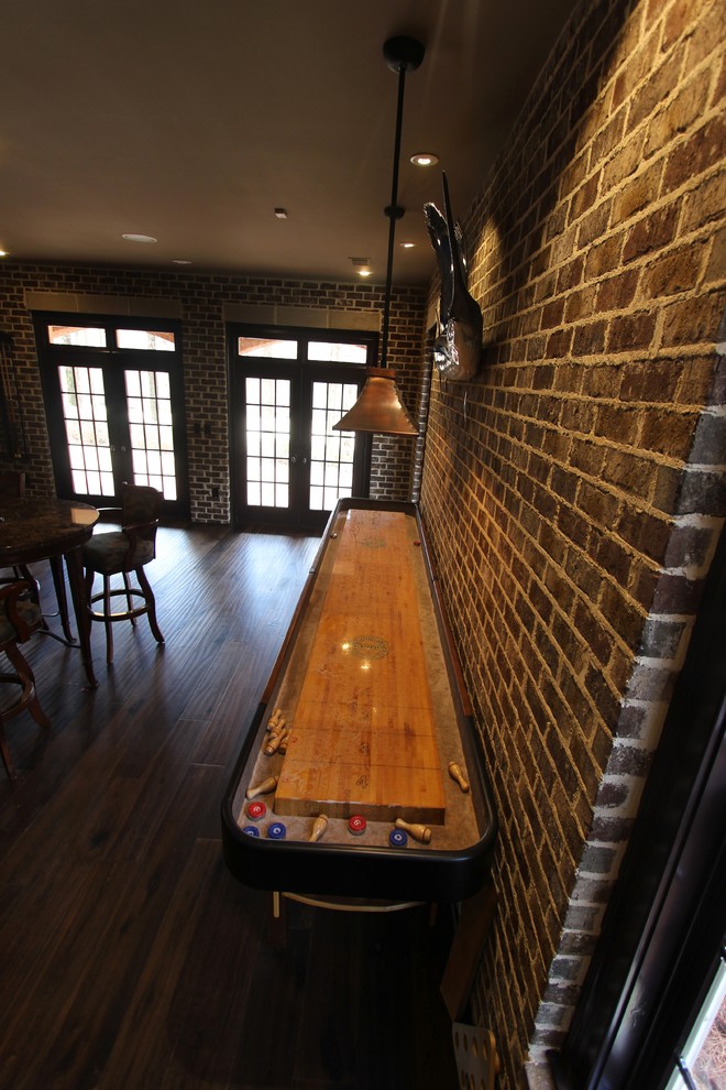 Basement - huge transitional walk-out medium tone wood floor basement idea with brown walls, a two-sided fireplace and a stone fireplace