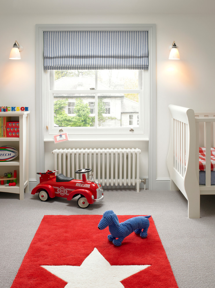 Photo of a mid-sized transitional kids' room for boys in London with grey walls, carpet and beige floor.