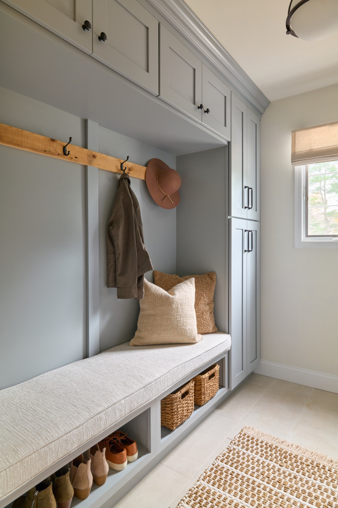 Mid-sized beach style porcelain tile and beige floor mudroom photo in New York with beige walls