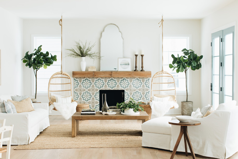 Inspiration for a beach style formal living room in Chicago with white walls, light hardwood floors, a standard fireplace, a tile fireplace surround, no tv and beige floor.