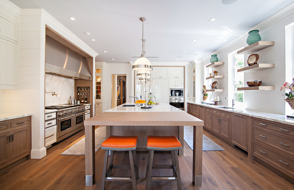 Huge transitional medium tone wood floor kitchen photo in Miami with an undermount sink, shaker cabinets, white cabinets, marble countertops, white backsplash, stone slab backsplash, white appliances and an island