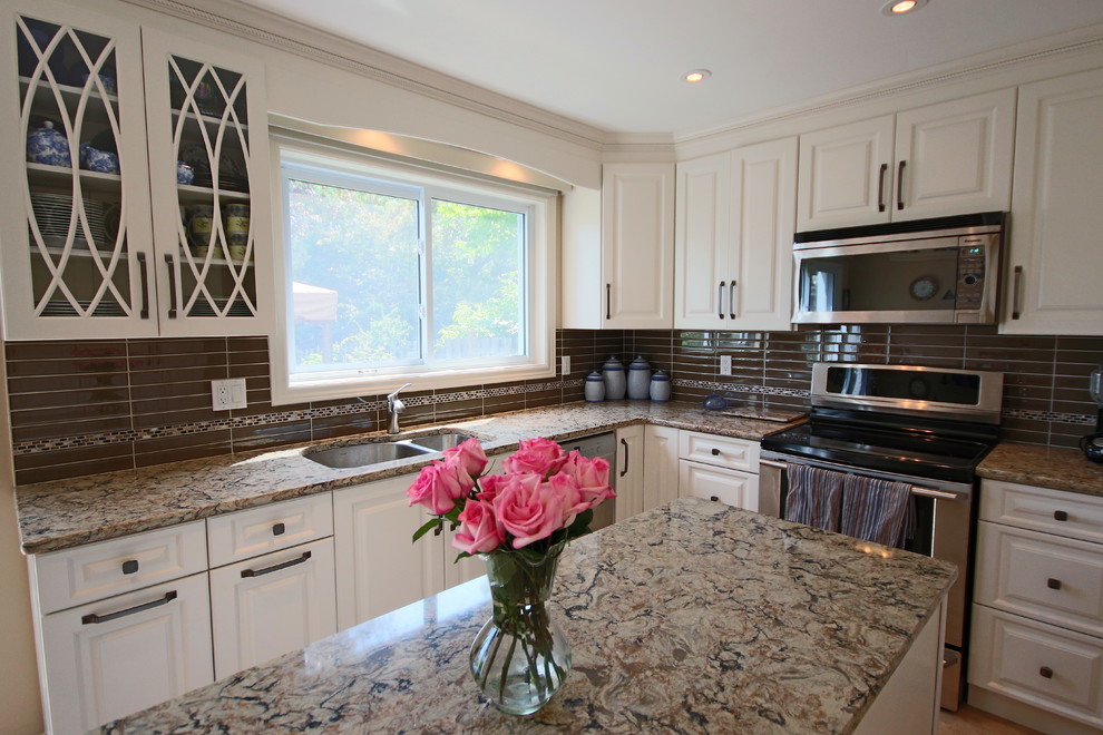 Example of a mid-sized transitional u-shaped cork floor enclosed kitchen design in Ottawa with an undermount sink, raised-panel cabinets, white cabinets, quartz countertops, brown backsplash, glass tile backsplash and an island