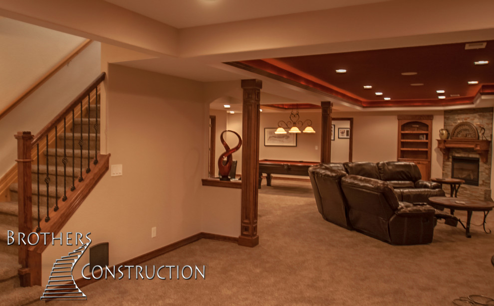 Photo of a mid-sized traditional fully buried basement in Denver with beige walls, carpet and a standard fireplace.