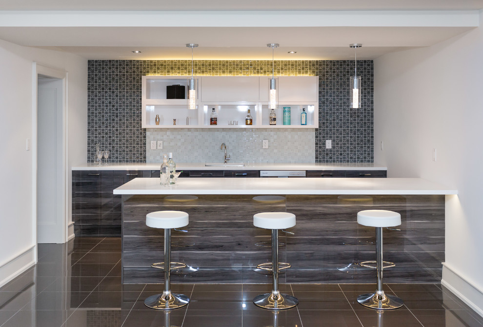 Design ideas for a mid-sized contemporary galley seated home bar in Toronto with an undermount sink, flat-panel cabinets, brown cabinets, solid surface benchtops, mosaic tile splashback, ceramic floors, brown floor and white benchtop.
