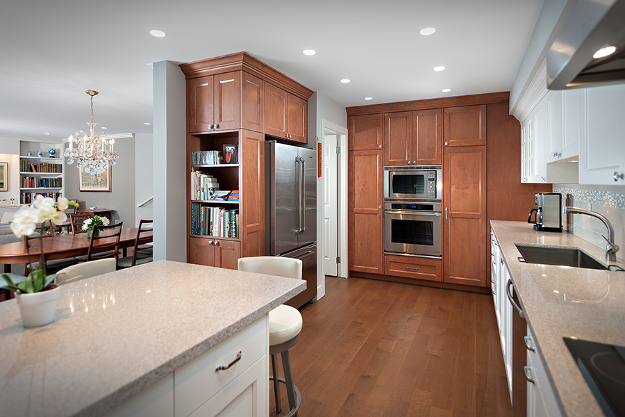 Example of a mid-sized transitional galley dark wood floor open concept kitchen design in Vancouver with granite countertops, white backsplash, stainless steel appliances and an island