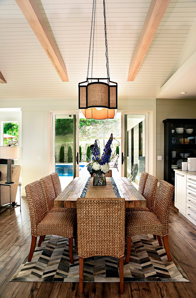 Example of a beach style medium tone wood floor great room design