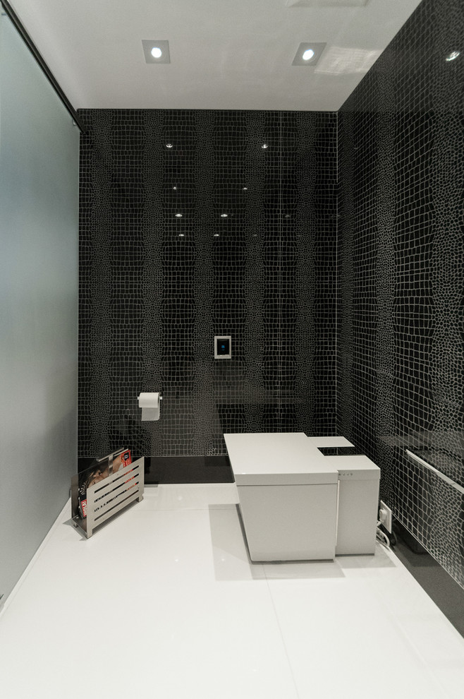 This is an example of a contemporary bathroom in Miami with a wall-mount sink, flat-panel cabinets, white cabinets, solid surface benchtops, white tile and glass tile.