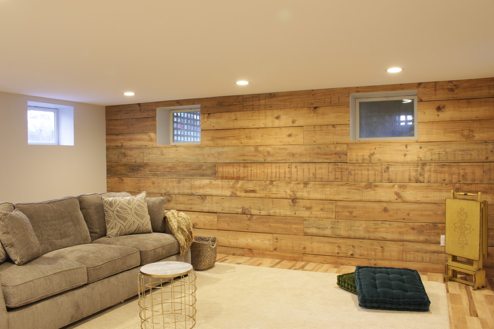 Inspiration for a mid-sized country look-out basement in New York with beige walls, laminate floors, no fireplace and brown floor.