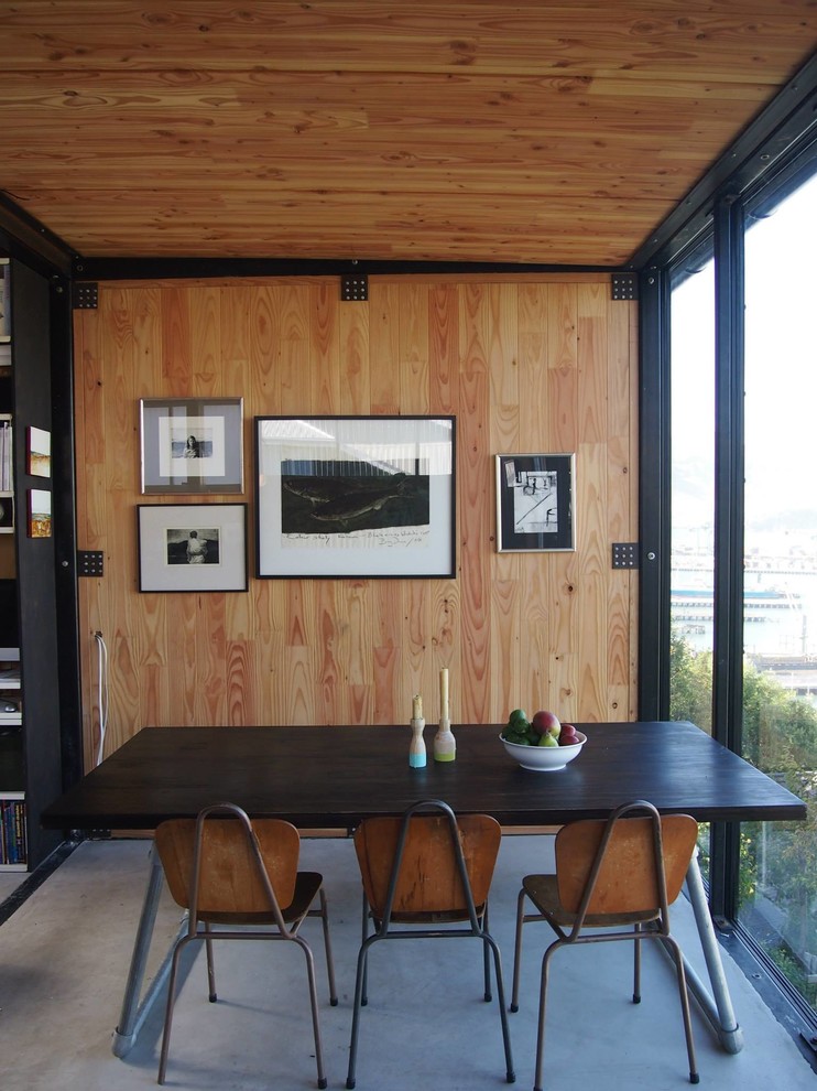 Design ideas for a small eclectic dining room in Christchurch with brown walls and concrete floors.