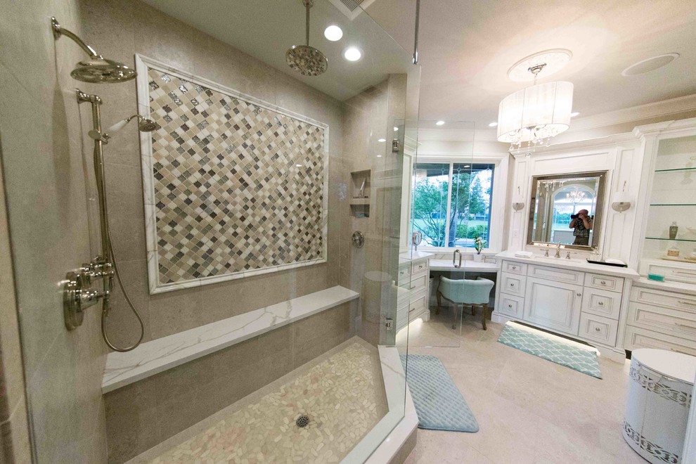 This is an example of a large transitional master bathroom in Other with raised-panel cabinets, white cabinets, a double shower, a one-piece toilet, beige tile, grey walls, an undermount sink, marble benchtops, a hinged shower door and white benchtops.