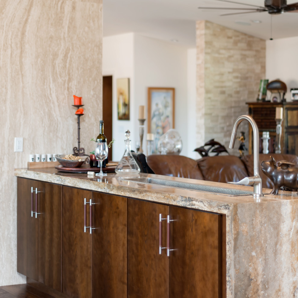 Mid-sized modern single-wall wet bar in Phoenix with an undermount sink, flat-panel cabinets, medium wood cabinets, limestone benchtops and medium hardwood floors.