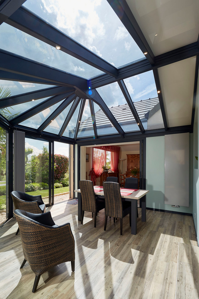 Contemporary sunroom in Other with laminate floors, no fireplace, a skylight and beige floor.