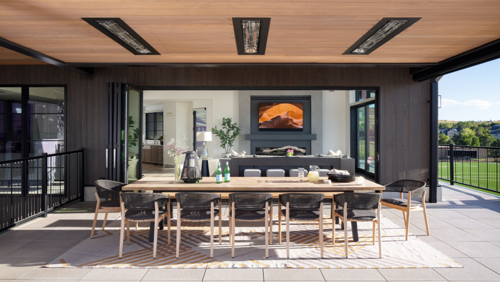 Deck - transitional backyard second story metal railing deck idea in Denver with a roof extension