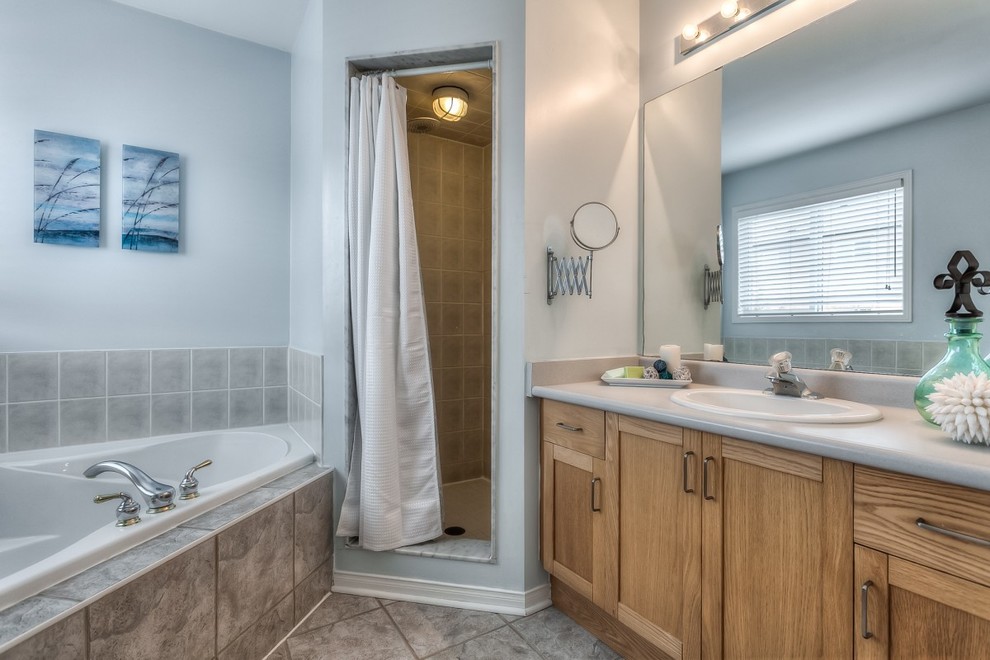 Mid-sized transitional master brown tile and ceramic tile bathroom photo in Toronto with beaded inset cabinets, distressed cabinets, laminate countertops and brown walls