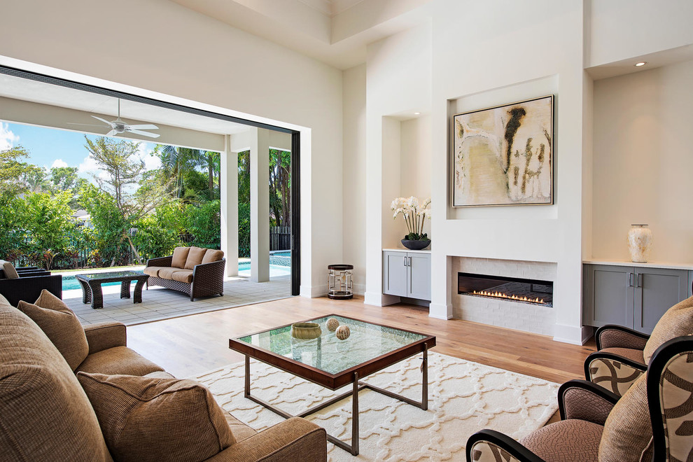 Inspiration for a contemporary open concept light wood floor living room remodel with white walls and a ribbon fireplace