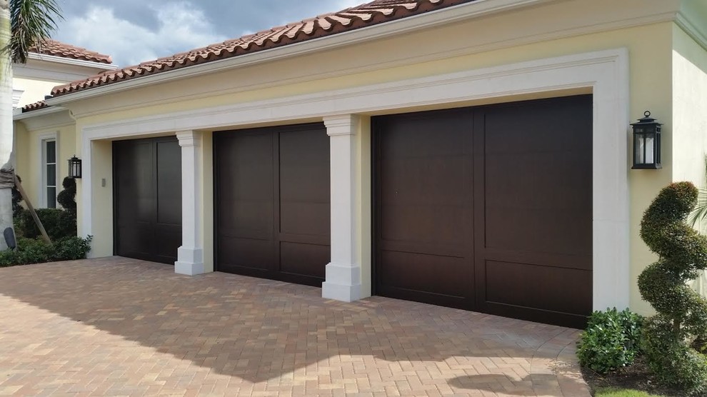 This is an example of a mid-sized traditional attached two-car garage in Miami.